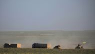 Trucks and a military vehicle for the Syrian Democratic Forces (SDF) move near Baghouz, Deir Al Zor, province, Syria, February 19, 2019. Reuters/Rodi Said