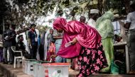 A Nigerian woman casts her vote for a candidate in the presidential election at Agiya polling station a few hours before polls opened in Yola, Adamawa State, Nigeria on February 23, 2019. / AFP / Luis TATO 