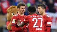 Bayern Munich's Thomas Mueller celebrates with David Alaba at the end of the match REUTERS/Andreas Gebert