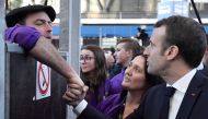 French President Emmanuel Macron (R) speaks with a farmer as he visits the 56th International Agriculture Fair (Salon de l'Agriculture) at the Porte de Versailles exhibition center in Paris February 23, 2019.  AFP / POOL / Julien DE ROSA
