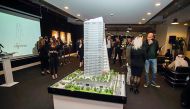 Guests pass by the replica of e18hteen Tower during the event.