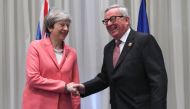Britain's Prime Minister Theresa May (L) greets the European Commission President Jean-Claude Juncker during a meeting on the sidelines of the first joint European Union and Arab League summit at the International Congress Centre in the Egyptian Red Sea r