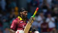 Chris Gayle (R) of West Indies celebrates his century during the 1st ODI between West Indies and England at Kensington Oval, Bridgetown, Barbados, on February 20, 2019. / AFP / Randy Brooks

