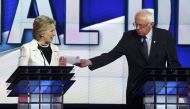 Hillary Clinton reacts as rival Bernie Sanders tries to hand her a piece of paper during a Democratic debate hosted by CNN and New York One at the Brooklyn Navy Yard, April 14, 2016. Reuters / Lucas Jackson