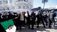 Police officers try to disperse people trying to reach the government palace during a protest against President Abdelaziz Bouteflika's plan to extend his 20-year rule by seeking a fifth term in April elections in Algiers, Algeria, March 1, 2019. REUTERS/Z