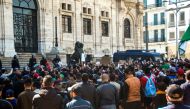 Algerians shout slogans and raise signs and national flags as they protest outside the city hall in the northern coastal city of Oran, about 410 kilometres west of the capital Algiers, on March 1, 2019, during a rally against ailing President Abdelaziz Bo