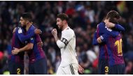 FC Barcelona's Lionel Messi, Luis Suarez and Gerard Pique celebrate victory as Real Madrid's Sergio Ramos walks off REUTERS/Sergio Perez