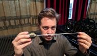 Vahakn Matossian poses for the camera holding his haptic baton which allows blind people to follow a conductor in an orchestra, in a studio in London, Britain February 21, 2019. Reuters/Stuart McDill