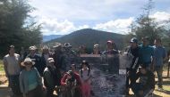 Residents of Tecoltemi indigenous land pose for a photo with a map of a mining project threatening their land in the town of Ixtacamaxtitlan, Mexico, Oct 30, 2018. Thomson Reuters Foundation/Karla Mendes 