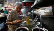 Hawker Leong Yuet Meng, 90, of Nam Seng Noodle House, poses as she cooks noodles at her shop in Singapore February 22, 2019. Picture taken February 22, 2019. REUTERS/Edgar Su