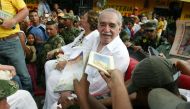 (FILES) In this file photo taken on May 30, 2007 Colombian author Gabriel Garcia Marquez, sitting with his wife Mercedes Barcha, is asked by admirers to dedicate them books, before boarding the train to his hometown Aracataca in Santa Marta, Colombia.  AF