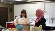 (Left to right) Chef Natalie Coleman and Manaza Nasa, volunteer at the Food Academy Community Fridge in the East Ham Leisure Centre, prepare a Spanish tortilla with products from the community fridge in London, United Kingdom, on March 6, 2019. Thomson Re