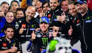 Monster Energy Yamaha MotoGP’s Maverick Vinales of Spain (centre), who clocked the best time yesterday, poses with his team at the end of the qualification session at the Losail International Circuit.