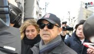 Former Nissan chairman Carlos Ghosn (C) is surrounded by the media as he goes out in Tokyo on March 9, 2019. Japan OUT / AFP / JIJI PRESS / JIJI PRESS