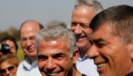 Blue and White party head Benny Gantz stands next to fellow party candidates during a visit to a kibbutz in Israel outside the northern Gaza Strip, March 13, 2019. Reuters/Amir Cohen