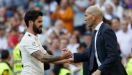 Real Madrid's Isco shakes hands with coach Zinedine Zidane REUTERS/Susana Vera