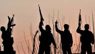 US-backed Syrian Democratic Forces (SDF) fighters celebrate after fighting Islamic State (IS) group jihadists near the village of Baghouz in the eastern Syrian province of Deir Ezzor, on March 15, 2019. AFP / GIUSEPPE CACACE