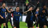 Inter Milan's Argentine forward Lautaro Martinez (L), Inter Milan's Italian midfielder Matteo Politano (C-R) and teammates celebrate winning the Italian Serie A football match AC Milan vs Inter Milan at the San Siro stadium in Milan. / AFP / Miguel MEDINA