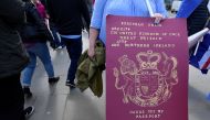 A mock-up of a British Passport is held by an anti-Brexit protester outside of the Houses of Parliament, in London, Britain, March 18, 2019. Reuters/Toby Melville