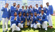 Afghanistan's team members pose with the trophy after winning the Test cricket match between Afghanistan and Ireland at the Rajiv Gandhi International Cricket Stadium in the northern Indian city of Dehradun on March 18, 2019. AFP / Money Sharma