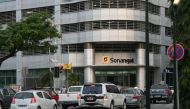 FILE PHOTO: Cars are seen infront of the head office of Angola's state oil company Sonangol in the capital Luanda, Angola June 7,2016. REUTERS