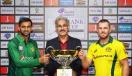 Pakiatani skipper Shoaib Malik (left) and Australaian captain Aaron Finch pose for a photograph yesterday with the JS Bank Cup which will be awarded to the winner of the five-match ODI series, starting in Sharjah today.