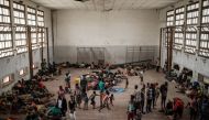 People from the isolated district of Buzi take shelter in the Samora M. Machel secondary school used as an evacuation center in Beira, Mozambique, on March 21, 2019, following the devastation caused by Cyclone Idai.  AFP / Yasuyoshi Chiba
 
