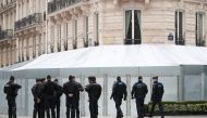 French gendarmes and riot police officers secure the Champs-Elysees avenue in front of the famed restaurant Fouquet's during the Act XIX (the 19th consecutive national protest on a Saturday) of the 