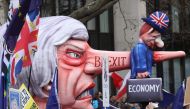 A puppet head of Britain's Prime Minister Theresa May spearing a representation of the British Economy is taken on a march and rally organised by the pro-European People's Vote campaign for a second EU referendum in central London on March 23, 2019. AFP /