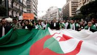 Lawyers carry a national flag as they march during a protest to demand the immediate resignation of President Abdelaziz Bouteflika, in Algiers, Algeria March 23, 2019. REUTERS/Ramzi Boudina
