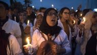 Young Moroccan school teachers hold candles as they protest against their current status in the capital Rabat on March 24, 2019. AFP / FADEL SENNA