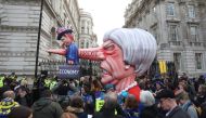 A puppet head of Britain's Prime Minister Theresa May spearing a representation of the British Economy is positioned on Whitehall outside Downing Street after a march and rally organised by the pro-European People's Vote campaign for a second EU referendu