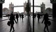 People walk through the More London business district with Tower Bridge seen behind in London, Britain, November 11, 2015. Reuters/Toby Melville