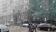 People cross a street amid a snow flurry in central Kiev, Ukraine March 27, 2019. Reuters/Gleb Garanich
