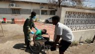 A medical staff member assists a man arriving at a cholera treatment centre set up in the aftermath of Cyclone Idai in Beira, Mozambique, March 29, 2019. Reuters/Mike Hutchings