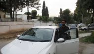 Haider Sultan, 23, a marketing executive who commutes each day between Rawalpindi and Islamabad, gets into a car-pool vehicle arranged through RASAI, a Pakistani ride sharing programme, March 27, 2019. Thomson Reuters Foundation/Imran Mukhtar