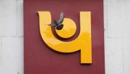 A pigeon flies past the logo of Punjab National Bank outside a branch of the bank in New Delhi, India, February 15, 2018. Reuters/Adnan Abidi