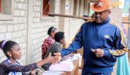FILE PHOTO: Burundi President Pierre Nkurunziza is registered by an electoral official before casting his ballot at a polling centre during the constitutional amendment referendum at School Ecofo de Buye in Mwumba commune in Ngozi province, northern Burun