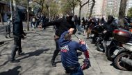 A Catalan pro-independence protester (back) scuffles with a supporter of Spanish far-right party Vox after pro-independence supporters staged a counter demonstration during a protest by Vox against the Catalan independence push in Barcelona on March 30, 2