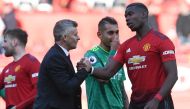 Manchester United's Norwegian manager Ole Gunnar Solskjaer (L) shakes hands with Manchester United's French midfielder Paul Pogba (R) after the final whistle of the English Premier League football match between Manchester United and Watford at Old Traffor