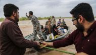 Iranian soldiers help civilians in a flooded area in a village around the city of Ahvaz, in Iran's Khuzestan province, on March 31, 2019. AFP / Tasnim News / Mehdi Pedramkhoo