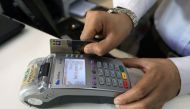 A salesman registers a credit card for a customer at a shop in Peshawar, Pakistan April 1, 2019. Reuters/Fayaz Aziz