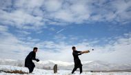 Afghan men play cricket on a field covered in snow on the outskirts of Kabul, Afghanistan December 16, 2017. Reuters/Mohammad Ismail