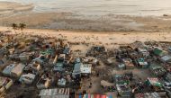 Debris and destroyed buildings which stood in the path of Cyclone Idai can be seen in this aerial photograph over the Praia Nova neighbourhood in Beira on April 1, 2019.  AFP / Guillem Sartorio
