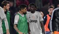 Juventus' Portuguese defender Joao Cancelo (C-L) comforts Juventus' Italian forward Moise Kean at the end of the Italian Serie A football march Cagliari vs Juventus on April 2, 2019 at the Sardignia Arena in Cagliari, after Cagliari's fans threw projectil