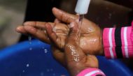 A Congolese child washes her hands as a preventive measure against Ebola at the Church of Christ in Mbandaka, Democratic Republic of Congo May 20, 2018. Reuters/Kenny Katombe