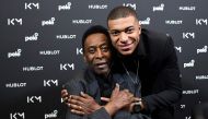 Paris Saint-Germain (PSG) and France national football team forward Kylian Mbappe (R) and Brazilian football legend Pele pose during their meeting at the Hotel Lutetia in Paris on April 2, 2019. AFP / Franck Fife
 