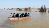 FILE PHOTO: People are seen on a boat after flooding in Golestan province, Iran, March 24, 2019. 