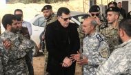 The head of Libya's UN-backed unity government, Fayez al-Sarraj (C), visits military and security commanders of the government forces who supervised recapture of the checkpoint 27 in Janzour, between Tripoli and the coastal town of Zawiya on April 5, 2019