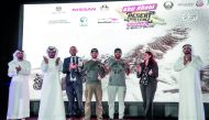 Qatari driver Mohammed Al Meer (second right) and his Russian co-driver Alexey Kuzmich (centre) celebrate with the trophies during the presentation ceremony of the 29th Abu Dhabi Desert Challenge, powered by Nissan at Yas Marina Circuit on Thursday. Al Me